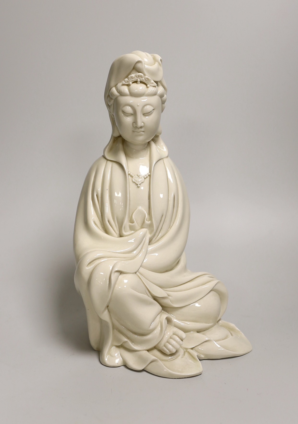 A signed Chinese Dehua blanc de Chine figure of Guanyin. 25cm high